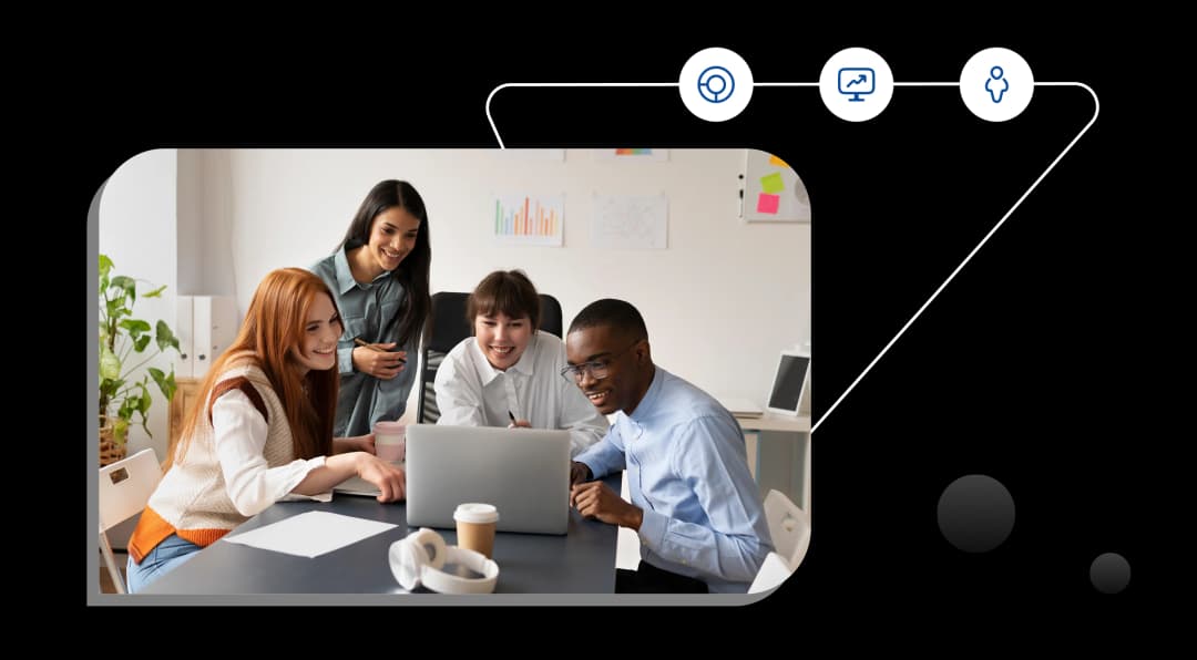 Team collaborating around a laptop